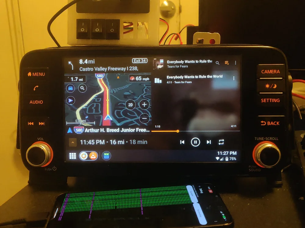 Picture of Flywheel with a map and some music playing in split-screen on an OEM Nissan Kicks headunit. The GPS data is simulated.